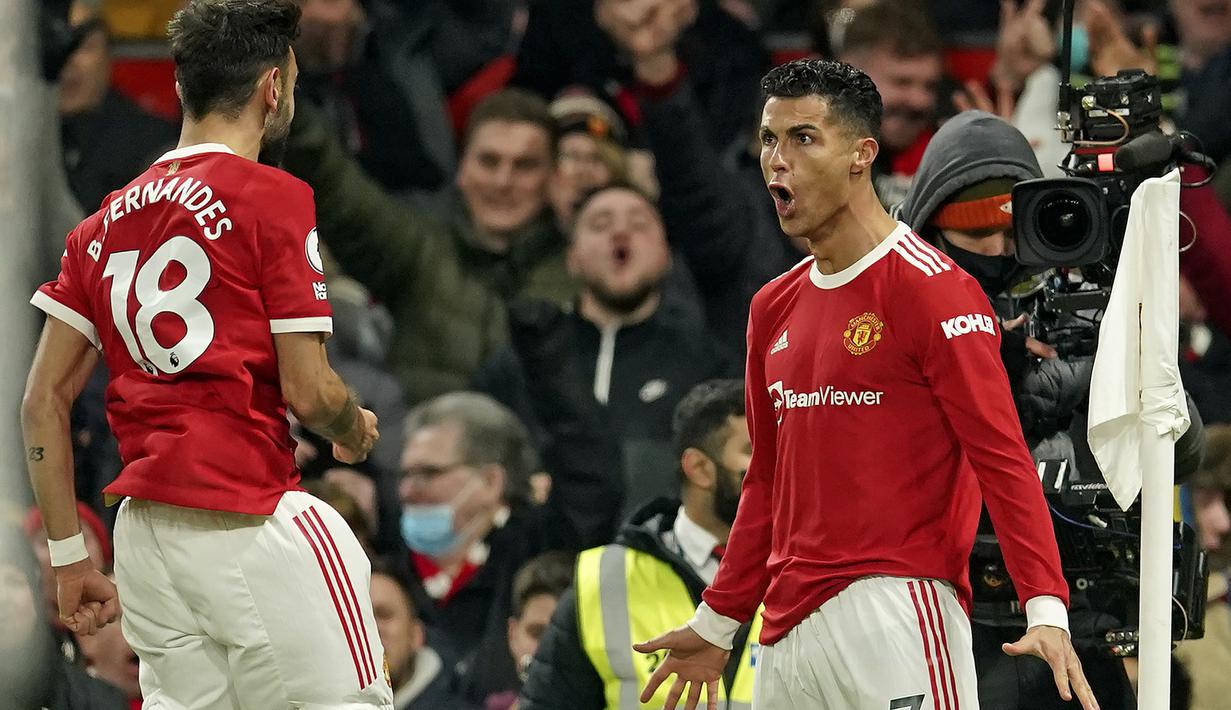 Manchester United. Di periode keduanya bersama Manchester United mulai musim 2021/2022 ini, Cristiano Ronaldo telah mencetak 12 gol dan 2 assist dari total 16 laga di semua ajang kompetisi. Gol ke-800 dan 801 dicetaknya saat mengalahkan Arsenal 3-2, 3 Desember 2021. (AP/Dave Thompson)