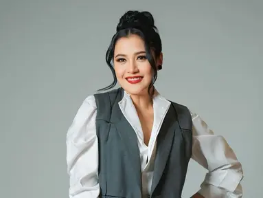 Tampil dengan kemeja putih dipadukan dengan blazer abu-abu dan kain lilit sebagai bawahannya, Fera Feriska bikin pangling. Rambut pemeran Dinda Lestari di sinetron Love Story The Series ini dicepol dengan juntaian di kiri dan kanannya. Makeup-nya flawless, namun Fera memoles bibirnya dengan lipstik warna merah yang membuat pesonanya semakin terpancar. (Liputan6.com/IG/@_feraferiska_)