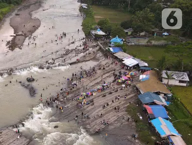 Foto udara menunjukkan wisatawan  berenang di aliran sungai Cipamingkis  Kecamatan Sukamakmur, kabupaten Bogor, Jawa Barat, Kamis (5/5/2022). Warga memanfaatkan aliran sungai tersebut sebagai sarana hiburan Hari Raya Idul Fitri 1443 Hijriah. (merdeka.com/Imam Buhori)