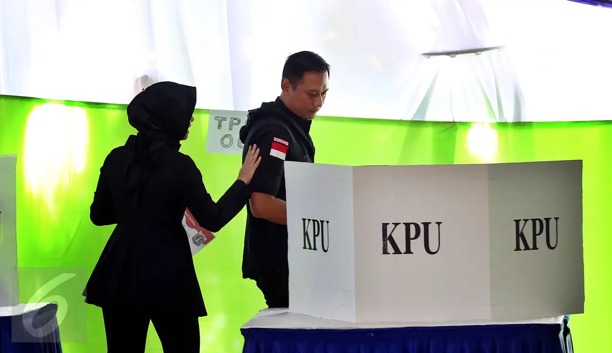 Calon Gubernur DKI Jakarta Agus Harimurti Yudhoyono memasuki bilik suara saat mengikuti proses pencoblosan Pilkada DKI 2017 di TPS 06, Rawa Barat, Jakarta, Rabu (15/2). Agus Yudhoyono juga datang mengajak anaknya, Almira. (Liputan6.com/Johan Tallo)