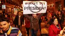 Pengunjuk rasa membawa poster bertuliskan "#Not My President" saat memprotes kemenangan Trump dalam pemilihan Presiden AS, di Chicago, Rabu (9/11). Mereka meneriakkan yel-yel bahwa Donald Trump "bukan presiden kami." (REUTERS/Kamil Krzacznski)