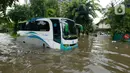 Bus pariwisata mogok terendam banjir yang menggenangi Jalan Letjen Suprapto, Jakarta, Pusat, Sabtu (8/2/2020). Hujan yang mengguyur Jakarta sejak semalam mengakibatkan Jalan Letjen Suprapto terendam banjir. (merdeka.com/Imam Buhori)