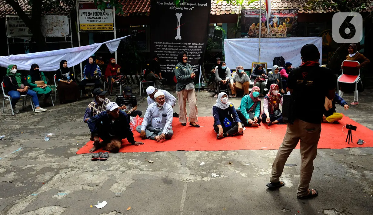 Orangtua murid bertahan dalam gedung saat pasukan Satpol PP hendak mengosongkan bangunan SDN Pondok Cina 1, Depok, Jawa Barat, Minggu (11/12/2022). Ketegangan dan adu argumentasi antara petugas dan sejumlah orang yang mengaku sebagai kuasa hukum orang tua siswa pun tak terhindarkan. (merdeka.com/Arie Basuki)