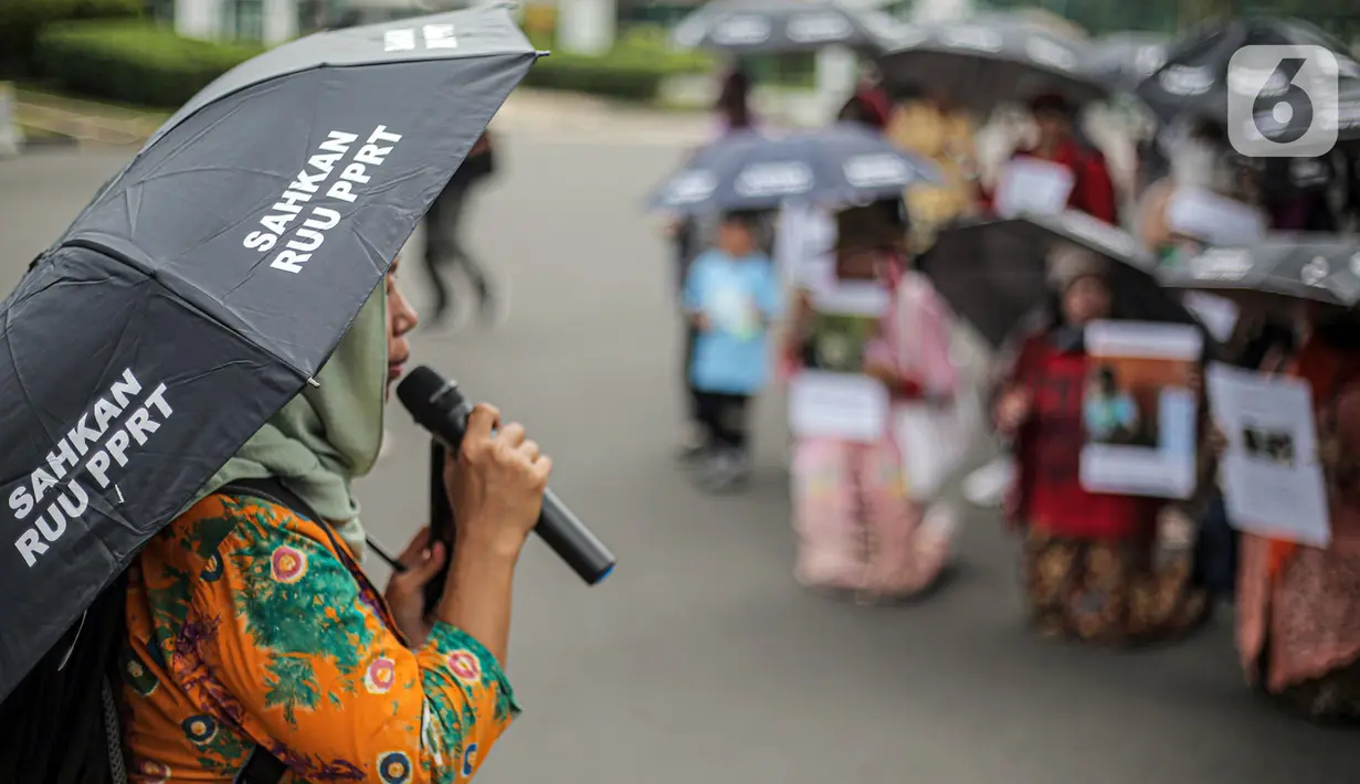 Pekerja rumah tangga (PRT) berorasi saat menggelar aksi di depan Taman Aspirasi Monas, Jakarta, Rabu (21/12/2022). Aksi tersebut dilakukan untuk memperingati Hari Ibu serta meminta pemerintah untuk mengesahkan Rancangan Undang-Undang Perlindungan Pekerja Rumah Tangga (RUU PPRT). (Liputan6.com/Faizal Fanani)