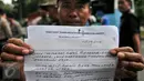Seorang tukang becak menunjukkan isi surat untuk Gubernur DKI, Basuki Tjahaja Purnama saat melakukan unjuk rasa di Balai Kota Jakarta, Kamis (28/1). Aksi ini bermula sejak 200 becak ditertibkan Satpol PP pada awal Januari 2016. (Liputan6.com/Yoppy Renato)