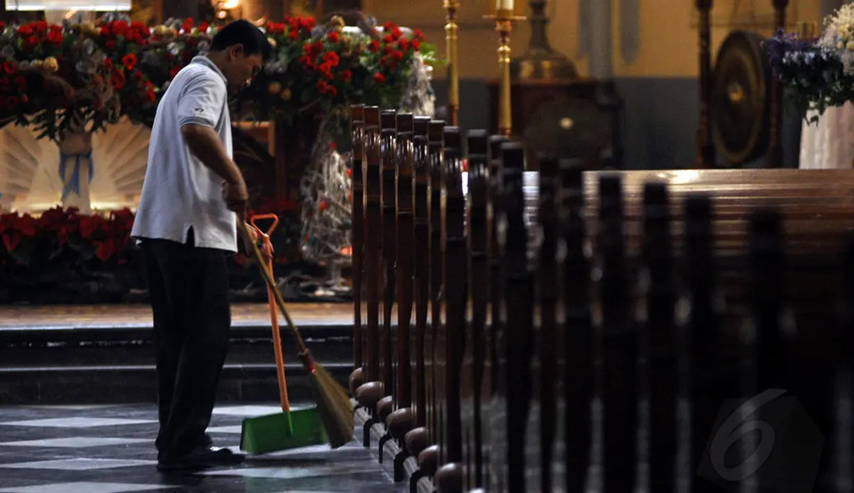 Petugas gereja Katedral terlihat membersihkan area gereja jelang Misa Malam Natal 2014 pada Rabu pagi (24/12/2014). (Liputan6.com/Miftahul Hayat)