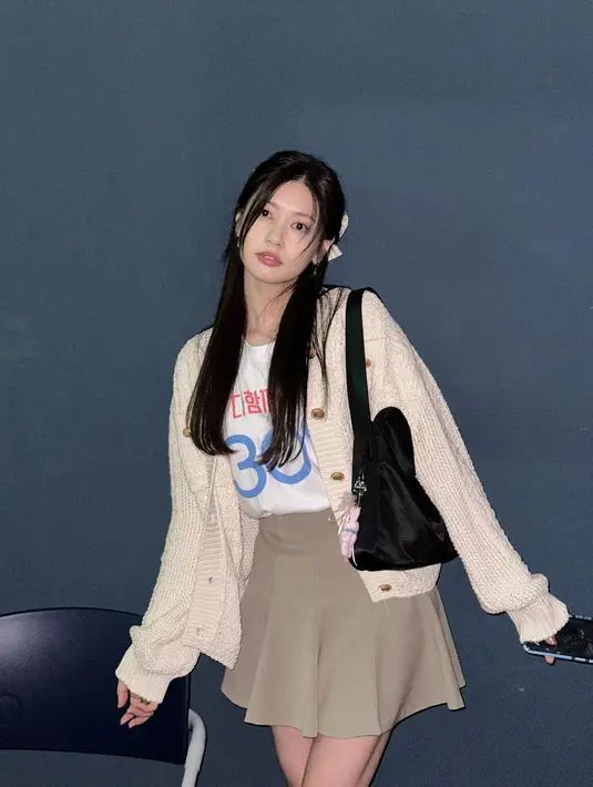 Jung So Min tampil chic mengenakan outfit bernuansa kecokelatan. Ia mengenakan kaus bercorak tulisan berwarna dasar putih, dengan sweater rajut beige, serta mini skirt berwarna cokelat. [Foto: Instagram/somin_jj]