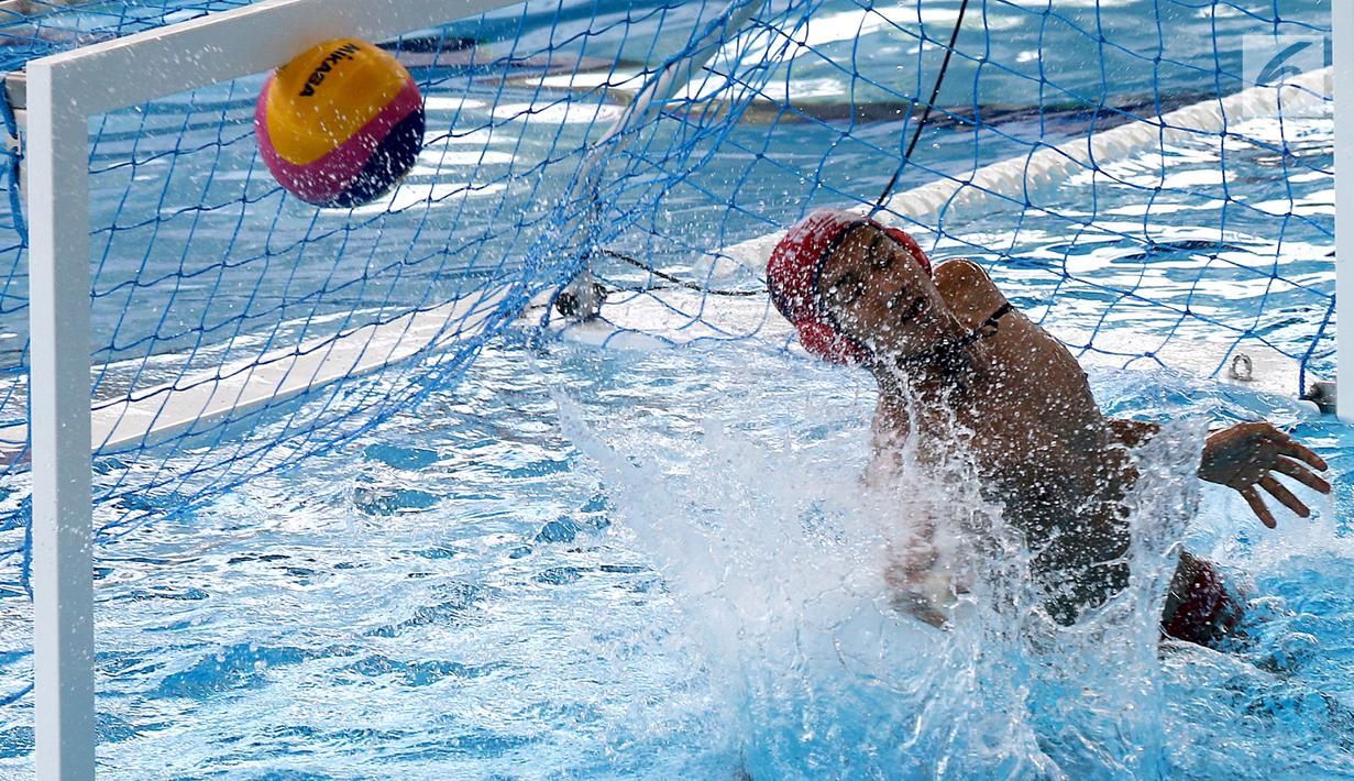 Penjaga gawang Polo Air Putra Indonesia, Novian Dwi Putra gagal menahan bola dari atlet Polo Air Putra Korea Selatan pada pertandingan babak semifinal putra peringkat 5 - 8 besar di Akuatik Center, Jakarta, Jumat (31/8).(Liputan6.com/Fery Pradolo)