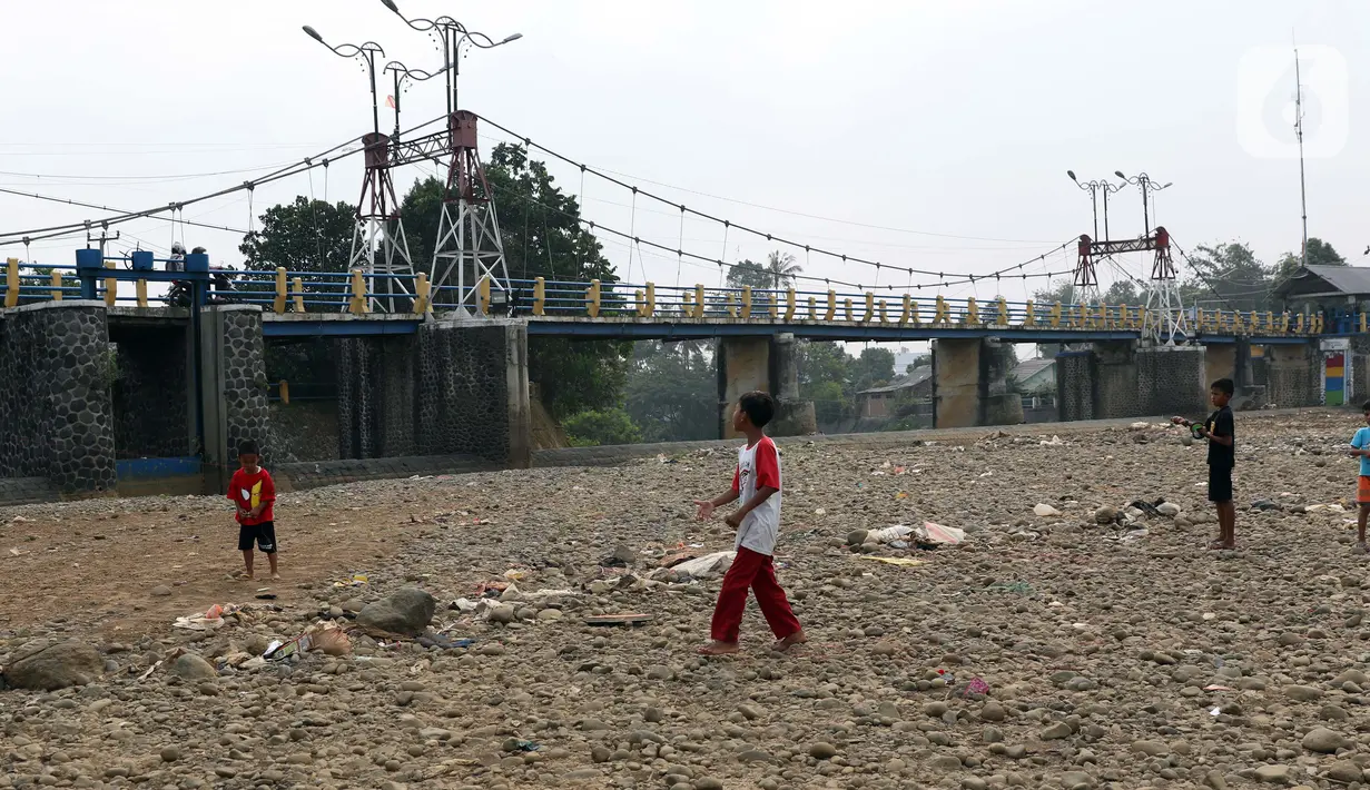 Anak-anak bermain di area Bendungan Katulampa, Kota Bogor, Jawa Barat, Senin (3/8/2020). Debit air sungai Ciliwung di Bendung Katulampa yang mengalami penyusutan sejak satu bulan terakhir dimanfaatkan anak-anak untuk bermain air dan layangan. (Liputan6.com/Helmi Fithriansyah)