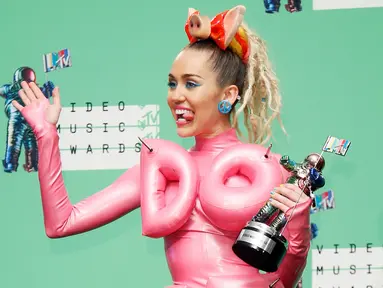 Miley Cyrus berpose di belakang panggung usai menjadi host di ajang bergengsi MTV VMA 2015 yang digelar di Microsoft Theatre, Los Angeles, California, AS (30/8/2015). (REUTERS/Danny Moloshok)