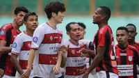 Pemain Madura United, Kim Jinsung (kiri) dan pemain Persipura Jayapura, Israel Wamiau bersitegang dalam laga pekan ke-6 BRI Liga 1 2021/2022 di Stadion Wibawa Mukti, Cikarang, Minggu (03/10/2021). (Bola.com/Bagaskara Lazuardi)