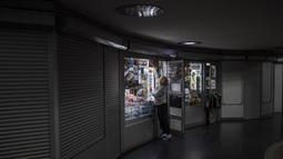 Seorang perempuan tokonya di dalam stasiun kereta bawah tanah di Kharkiv, Ukraina timur, Selasa (24/5/2022). Kereta bawah tanah Kharkiv kembali beroperasi pada Selasa pagi setelah ditutup selama lebih dari dua bulan selama upaya Rusia untuk merebut kota itu. (AP Photo/Bernat Armangue)