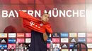 Pemain baru Bayern Munchen Arturo Vidal memakai kostum barunya saat jumpa pers perkenalan dirinya di Munich, Jerman, Selasa (28/7/2015). (AFP Photo/Christof Stache)