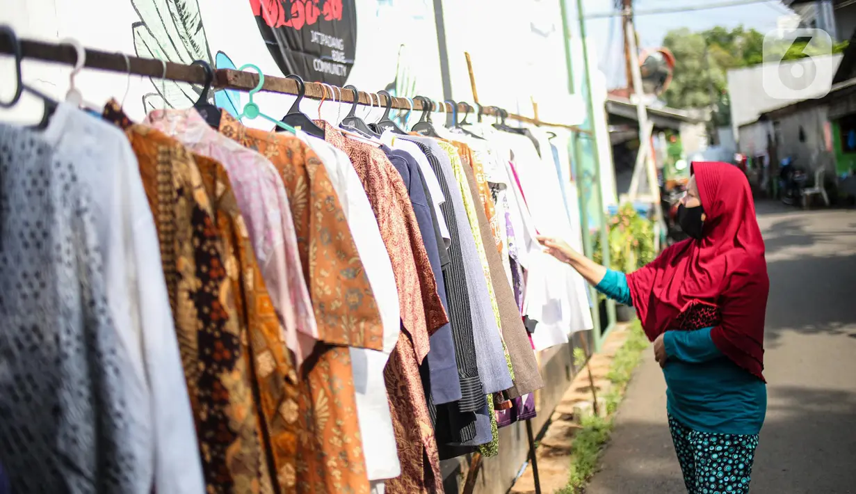 Warga memilih pakaian bekas layak pakai hasil sumbangan di RT 02 RW 04, Kelurahan Jati Padang, Jakarta, Jumat (22/5/2020). Pakaian bekas layak pakai serta sayur mayur disediakan bagi warga terdampak Pembatasan Sosial Berskala Besar (PSBB) untuk pencegahan COVID-19. (Liputan6.com/Faizal Fanani)