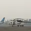 Pesawat Garuda mendarat di Bandara Sultan Thaha Jambi, di tengah kabut asap yang menyelimuti Kota Jambi, Selasa (17/9/2019). (Liputan6.com/Gresi Plasmanto)