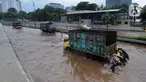 Anggota Brigif 17 Kostrad TNI AD yang kebetulan lewat bersama-sama mendorong truk yang mogok saat banjir menggenangi Jalan Tol JORR di kawasan TB Simatupang, Jakarta Selatan, Sabtu (20/2/2021). Banjir terjadi akibat luapan Kali Serua yang berada di pinggir jalan tol. (merdeka.com/Arie Basuki)