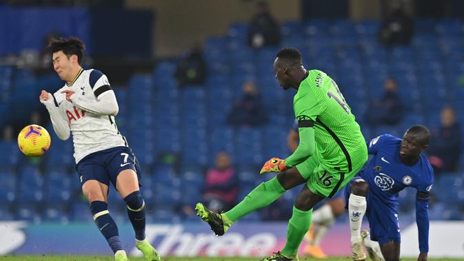 Kiper Chelsea, Edouard Mendy menendang bola menjauh dari penyerang Tottenham Hotspur, Son Heung-Min paada pekan ke-10 Liga Inggris 2020/2021 di Stamford Bridge, Minggu (29/11/2020). Derby London antara Tottenham Hotspur kontra Chelsea berakhir imbang tanpa gol. (JUSTIN TALLIS/POOL/AFP)