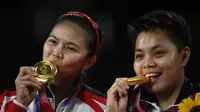 Ganda putri Indonesia Greysia Polii / Apriyani Rahayu berpose dengan medali emas badminton Olimpiade Tokyo 2020 di Musashino Forest Sports Plaza, Tokyo, Jepang, Senin, 2 Agustus 2021. (Alexander NEMENOV / AFP)