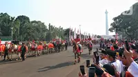 Rangkaian upacara peringatan detik-detik proklamasi kemerdekaan RI di Halaman Istana Merdeka dimulai dengan Kirab Bendera Pusaka dan Teks Proklamasi dari Silang Monas Jalan Medan Merdeka Barat menuju Istana Merdeka. (Liputan6.com/Angga Yuniar)