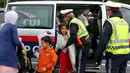 Polisi Austria membantu imigran saat tiba di stasiun Nickelsdorf, Austria, Sabtu (5/9/2015). Sekitar 2.000 imigran menembus Austria setelah pemerintah Hungaria mengizinkan para pencari suaka ke negara selanjutnya. (REUTERS/Heinz-Peter Bader)