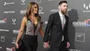 Bintang Barcelona, Lionel Messi dan istrinya Antonella Roccuzzo, bergandengan tangan saat menghadiri sesi pemotretan acara terbaru Cirque du Soleil "Messi 10" di Barcelona, (31/1/2019). (AFP/Lluis Gene)