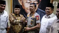 Kapolri Jenderal Pol Idham Azis menjabat tangan Ketum PBNU Said Aqil Siradj saat menyambangi Gedung PBNU di Jakarta, Selasa (12/11/2019). Kedatangan Idham merupakan tradisi pimpinan polri yang selalu menjalin silaturahmi dengan komponen masyarakat, salah satunya PBNU. (Liputan6.com/Faizal Fanani)