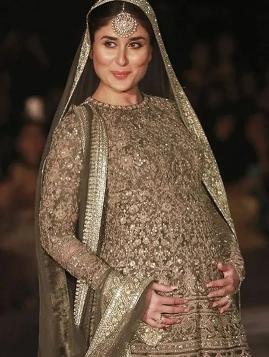 Berada di masa kehamilan, aktris kelahiran mumbai ini terlihat menjadi  sebuah model yang memeragakan pakaian Sari India. Aura seorang ibu tampak di wajah Kareena yang sedang berpose sambil memegang perut buncitnya. (Instagram/kareenabebo)