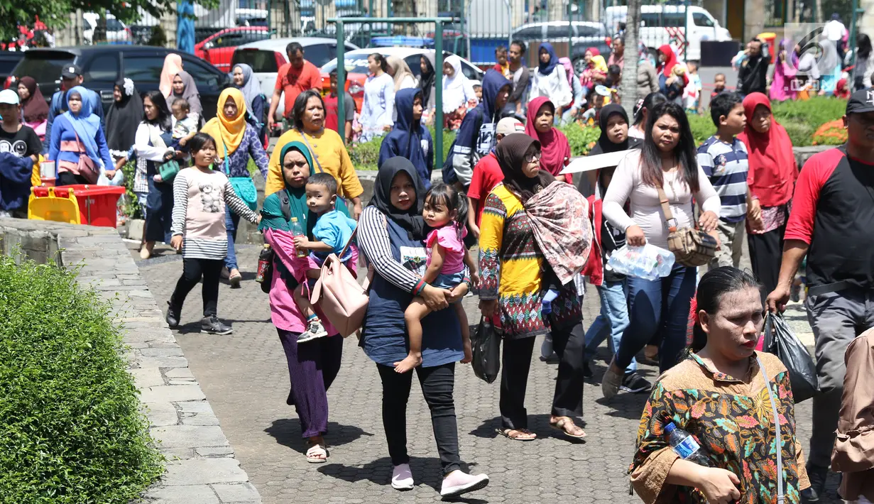 Warga memadati lajur pintu masuk kawasan Kebun Binatang Ragunan, Jakarta, Minggu (30/12). Libur panjang jelang pergantian tahun dimanfaatkan warga untuk berlibur di kawasan Kebun Binatang Ragunan. (Liputan6.com/Helmi Fithriansyah)