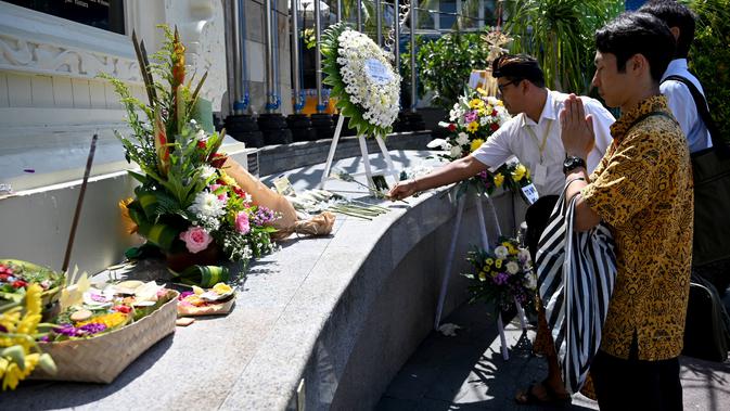 Seorang pria asal Jepang berdoa di Monumen Bom Bali, Kuta, dekat Denpasar pada Sabtu (12/10/2019). MeMperingati 18 tahun peristiwa bom Bali yang terjadi pada 12 Oktober 2002, wisatawan dan kerabat korban mengunjungi tugu peringatan untuk berdoa dan tabur bunga. (SONNY TUMBELAKA / AFP)