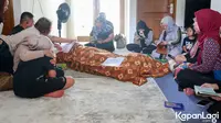 Jenazah mendiang Farida disemayamkan di ruang keluarga. Tampak para kerabat pun membacakan doa untuk mendiang.  [KapanLagi.com®/Muhammad Akrom Sukarya]