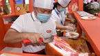 Para peserta pameran menyiapkan produk daging dalam Pameran Industri Daging Internasional China ke-18 di Qingdao, Provinsi Shandong, China, 10 September 2020. (Xinhua/Li Ziheng)