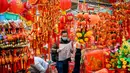 Seorang pria (tengah) membeli dekorasi di Hong Kong (14/1/2021). Warga Hong Kong mulai berburu pernak-pernik Tahun Baru Imlek seperti lampion, kartu Imlek, baju, dan hiasan rumah. (AFP/Anthony Wallace)
