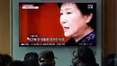 Warga menyaksikan layar TV yang menyiarkan berita tentang mantan presiden Korea Selatan Park Geun-hye, Seoul, Korea Selatan, Jumat (6/4). Pengadilan Korea Selatan menjatuhkan hukuman penjara selama 24 tahun untuk Park Geun-hye. (AP Photo/Lee Jin-man)