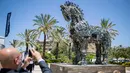 Seorang pria mengambil gambar patung kuda troya bernama "Cyber Horse" yang terbuat dari ribuan komputer dan komponen ponsel yang terinfeksi virus, di pintu masuk konferensi Cyber Week tahunan di Tel Aviv University, Israel, Senin (20/6). (Jack GUEZ/AFP)