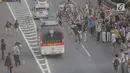 Massa aksi melempari kendaraan dinas milik polisi yang melintasi jalan tol seberang Gedung DPR/ MPR RI, Jakarta, Selasa (24/9/2019). Selain menutup ruas tol, kendaraan dinas pemerintah dan milik polisi jadi korban pelemparan dan perusakan oleh mahasiswa. (Liputan6.com/Faizal Fanani