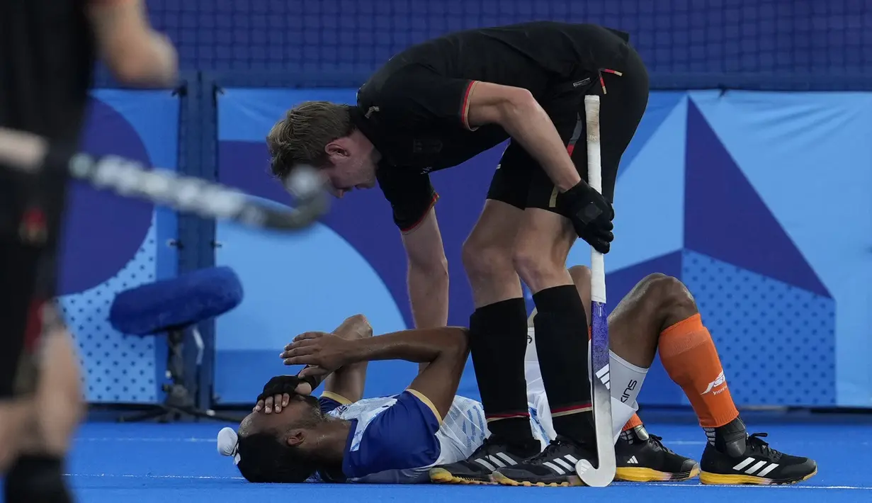 Atlet hoki India Hardik Singh dihibur oleh Niklas Wellen dari Jerman setelah India kalah dalam pertandingan hoki lapangan semifinal putra Olimpiade Paris 2024 di Stadion Yves-du-Manoir, Selasa, 6 Agustus 2024. (AP Photo/ Anjum Naveed)