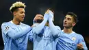 Pemain Manchester City Joao Cancelo (tengah) merayakan bersama rekan setimnya usai mencetak gol ke gawang Olympiacos pada pertandingan Grup C Liga Champions di Etihad Stadium di Manchester, Inggris, Selasa (3/11/2020). Manchester City mencukur Olympiacos dengan skor 3-0. (AP Photo/Dave Thompson)