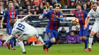 Aksi bintang Barcelona, Lionel Messi (tengah), saat mencoba melewati para pemain Real Madrid, pada laga lanjutan La Liga, di Stadion Camp Nou, Sabtu (3/12/2016). (AFP/Pau Barrena). 