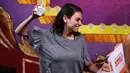 Aktris Mila Kunis melempar donat dalam sebuah presentasi penghargaan di Cambridge (25/1). Mila Kunis dinobatkan sebagai "Woman of the Year" oleh kelompok teater Hasty Pudding. (AP Photo / Charles Krupa)