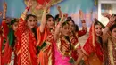 Gadis-gadis India berpakaian tradisional menari saat mereka merayakan festival Lohri di Jammu, India (13/1). Beberapa orang percaya bahwa perayaan tersebut untuk memperingati terjadinya titik balik musim dingin. (AP Photo / Channi Anand)