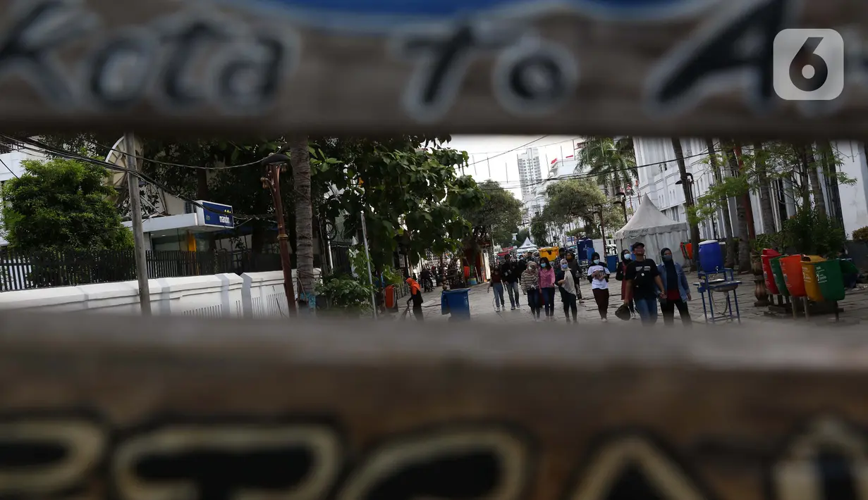 Warga berjalan-jalan di kawasan wisata Kota Tua Jakarta, Rabu (9/12/2020). Libur pelaksanaan Pilkada Serentak 2020 dimanfaatkan sejumlah warga untuk berwisata di kawasan Kota Tua Jakarta. (Liputan6.com/Helmi Fithriansyah)