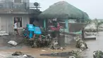 Seorang pria berjalan melewati kerusakan yang disebabkan oleh banjir bandang pada Kamis 24 Oktober 2024 di kota Libon, provinsi Albay, Filipina. (AP Photo/John Michael Magdasoc)