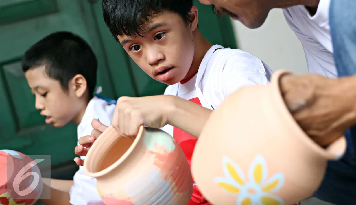 Penyandang disabilitas tampak serius menyelesaikan lukisan keramiknya di Museum Seni Rupa dan Keramik, Jakarta, Jumat (23/10). Kegiatan untuk meningkatkan kemampuan dan keterampilan seni bagi penyandang disabilitas . (Liputan6.com/Immanuel Antonius)