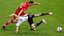 Pemain Jerman, Thomas Muller, terjatuh saat berebut bola dengan pemain Polandia, Grzegorz Krychowiak, pada laga kedua Grup C Piala Eropa 2016 di Stade de France, Jumat (17/6/2016) dini hari WIB. (Reuters/Charles Platiau)