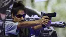 Seorang pengunjung memegang pistol yang diproduksi di India oleh PLR Systems di Defense Expo 2022, Gandhinagar, India, 18 Oktober 2022. Defense Expo 2022 ini akan berlangsung selama lima hari. (Sam PANTHAKY/AFP)