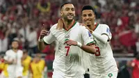 Pemain Maroko, Hakim Ziyech merayakan gol pertama timnya ke gawang Kanda saat matchday ketiga Grup F Piala Dunia 2022 di Al Thumama Stadium, Doha Kamis (01/12/2022). (AP/Pavel Golovkin)
