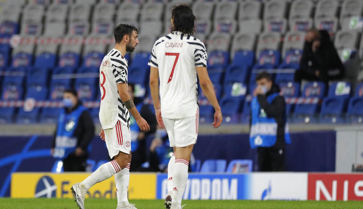 Pemain Manchester United, Bruno Fernandes dan Edinson Cavani tertunduk lesu meninggalkan lapangan usai ditaklukkan Istanbul Basaksehir pada laga Liga Champions di Stadion Fatih Terim, Kamis (5/11/2021). MU kalah dengan skor 2-1. (AP Photo)