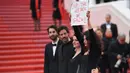 Aktris Manal Issa menujukkan poster bertuliskan "Hentikan Serangan di Gaza" saat menghadiri pemutaran film "Solo: A Star Wars Story" dalam Festival Film Cannes ke-71 di Cannes, Prancis (15/5). (AFP/Loic Venance)
