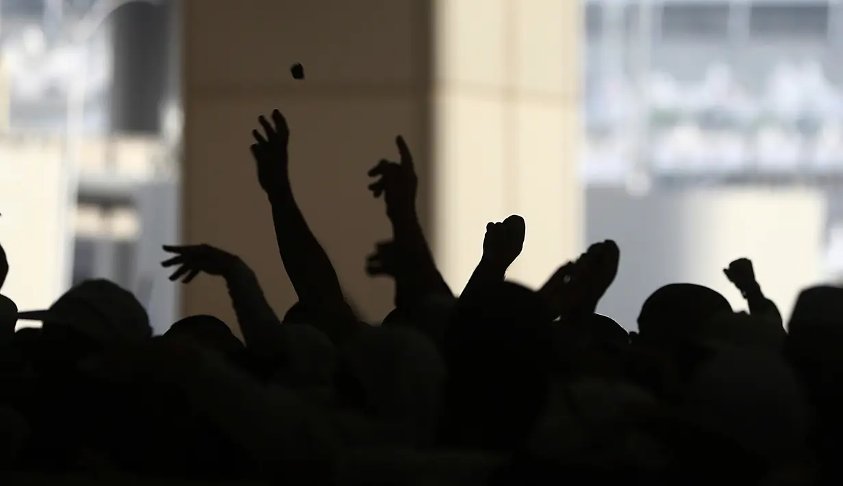 Jemaah haji melempar batu saat melaksanakan lempar jumrah di Mina, dekat kota suci Makkah, Arab Saudi, (2/9). Lempar jumrah merupakan simbol perlawanan terhadap setan. (AP Photo / Khalil Hamra)