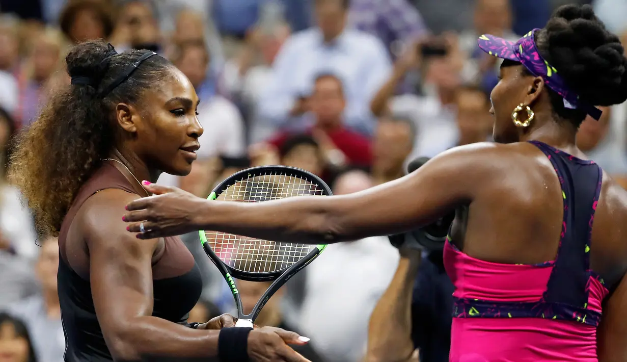 Petenis Serena Williams (kiri) menghampiri kakak perempuannya, Venus Williams usai bertanding di putaran ketiga turnamen tenis AS Terbuka di New York, Jumat (31/8). Serena mengalahkan Venus dengan skor 6-1, 6-2. (AP Photo/Adam Hunger)